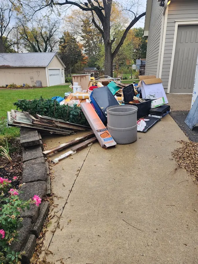 Dumpster being loaded with debris for 10 Yard Dumpster Rental in Pewaukee